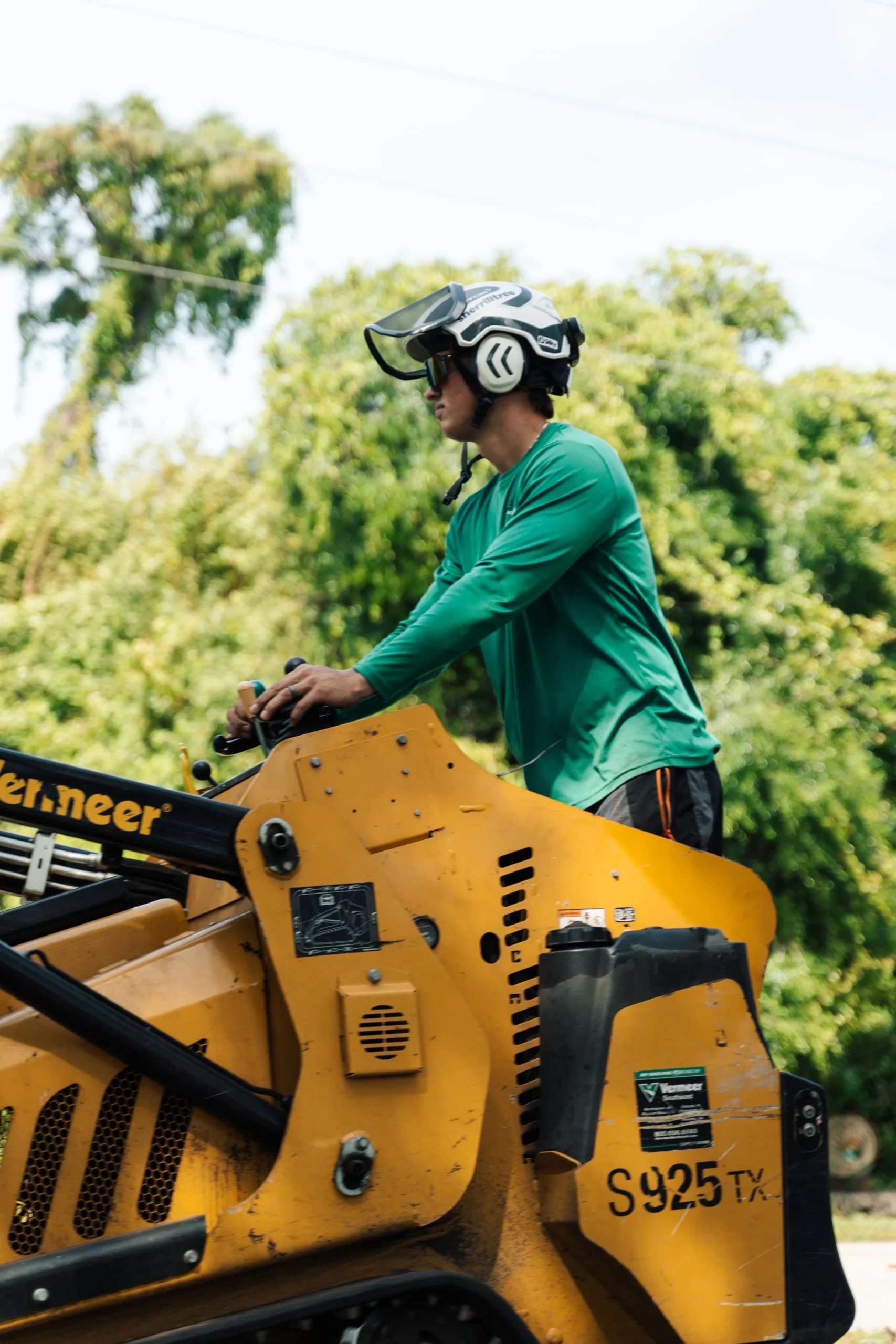 Excavator clearing land and removing tree stumps on a Florida residential lot