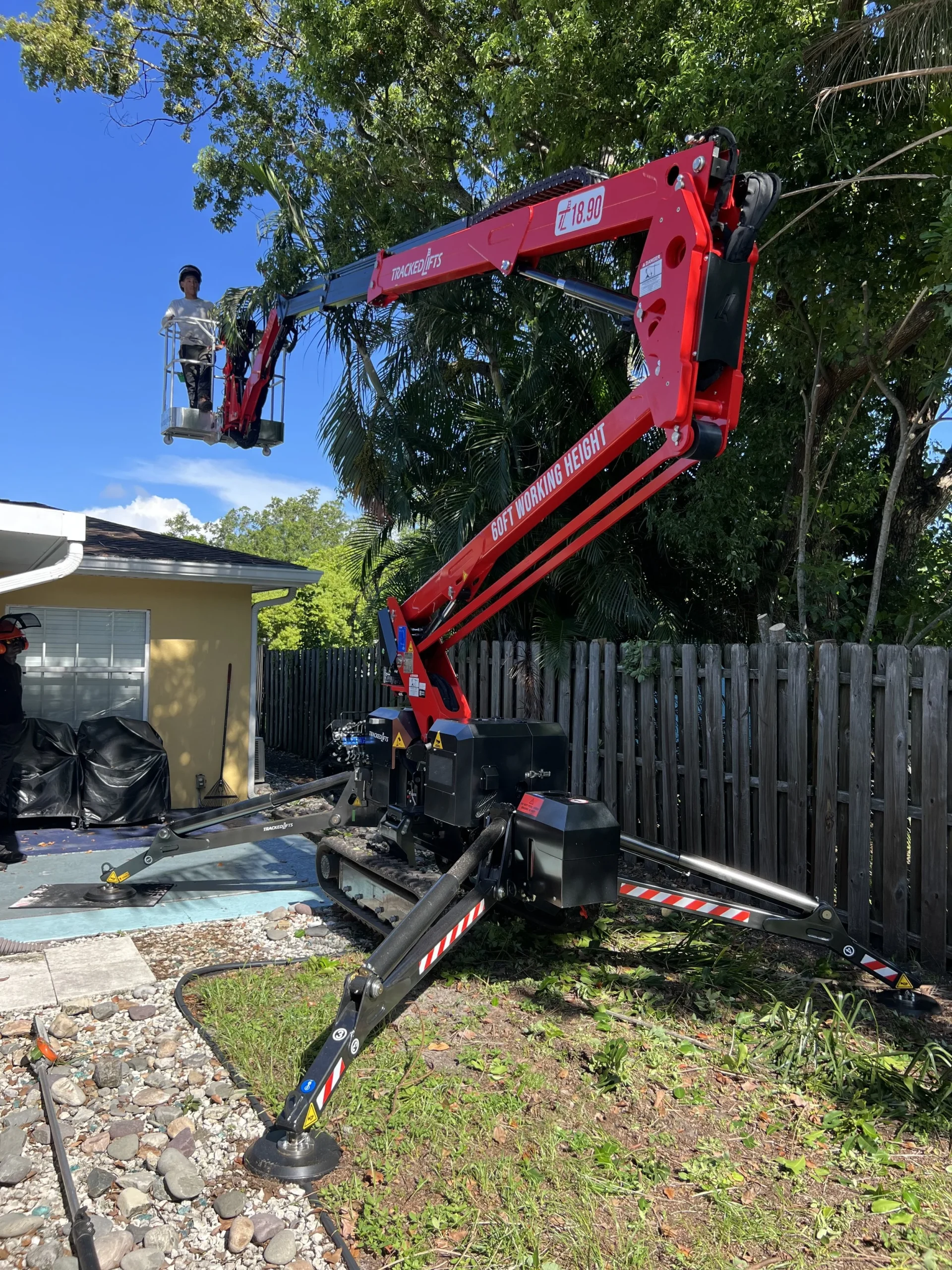 Stump grinding machine removing a large tree stump from a Sarasota yard