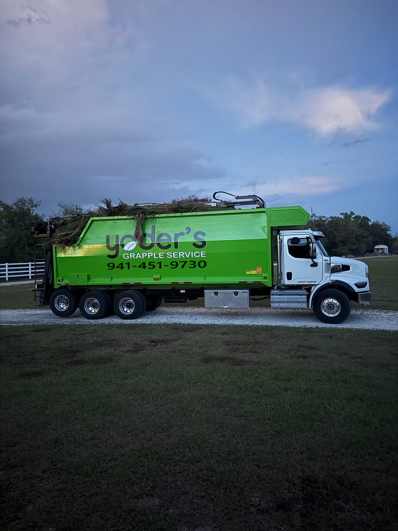 Grapple truck loaded with green waste debris in Sarasota FL