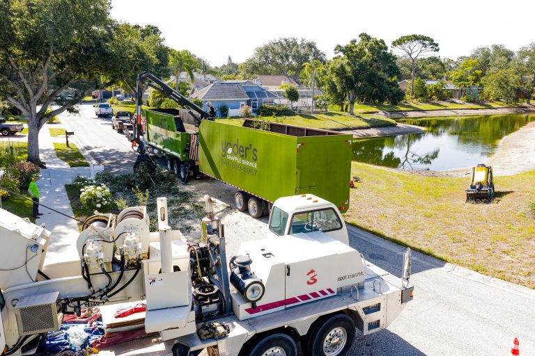 Yoders grapple truck hauling logs and debris in Sarasota FL