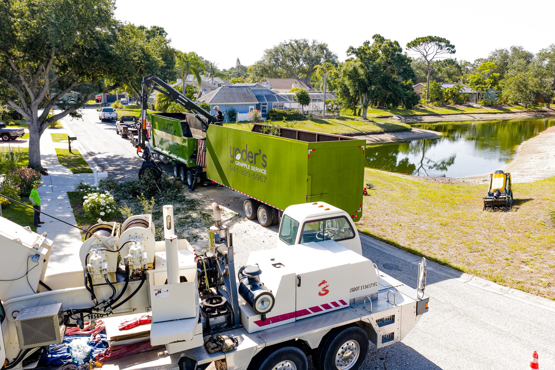 Aerial view of Yoders grapple truck hauling logs and debris in Sarasota FL