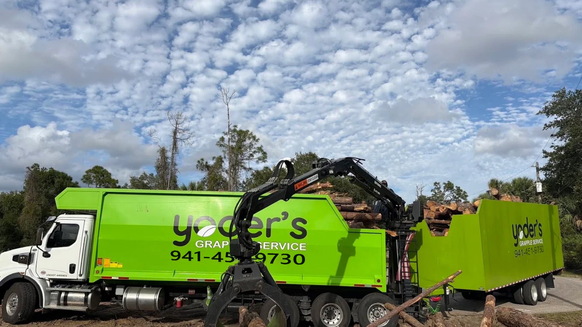 Grapple truck loading logs and debris for hauling in Sarasota FL